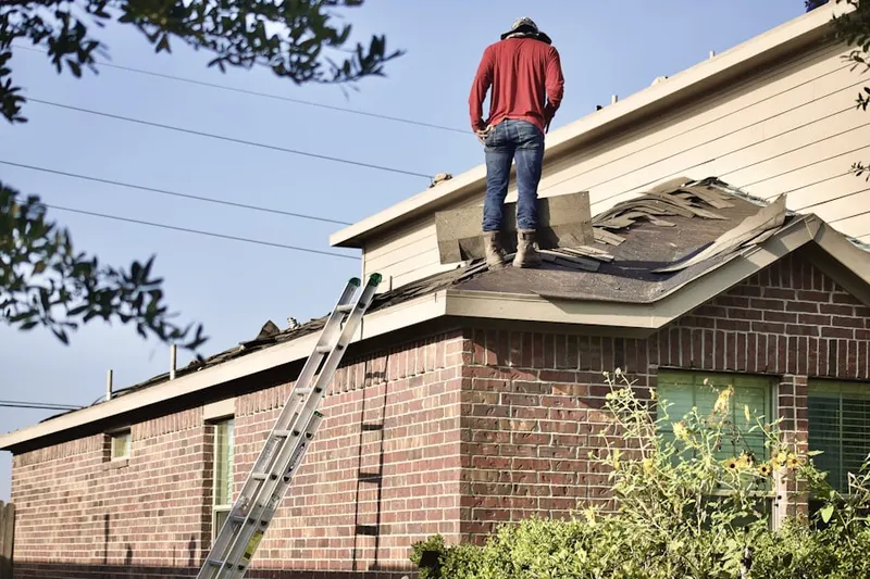Professional roofer working on a residential roof in Alameda